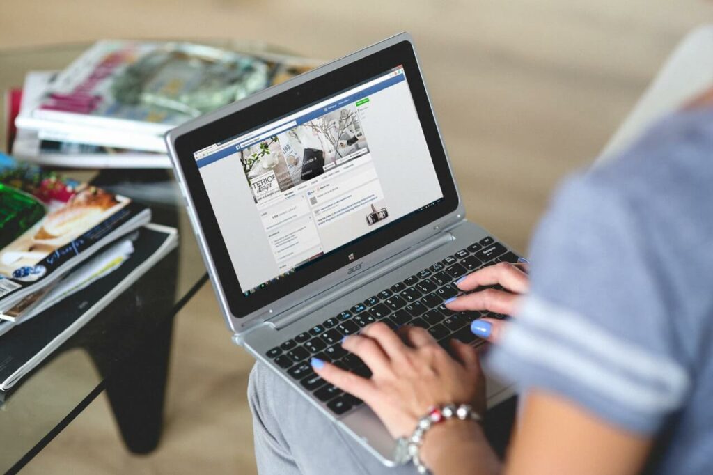 Man using facebook on laptop