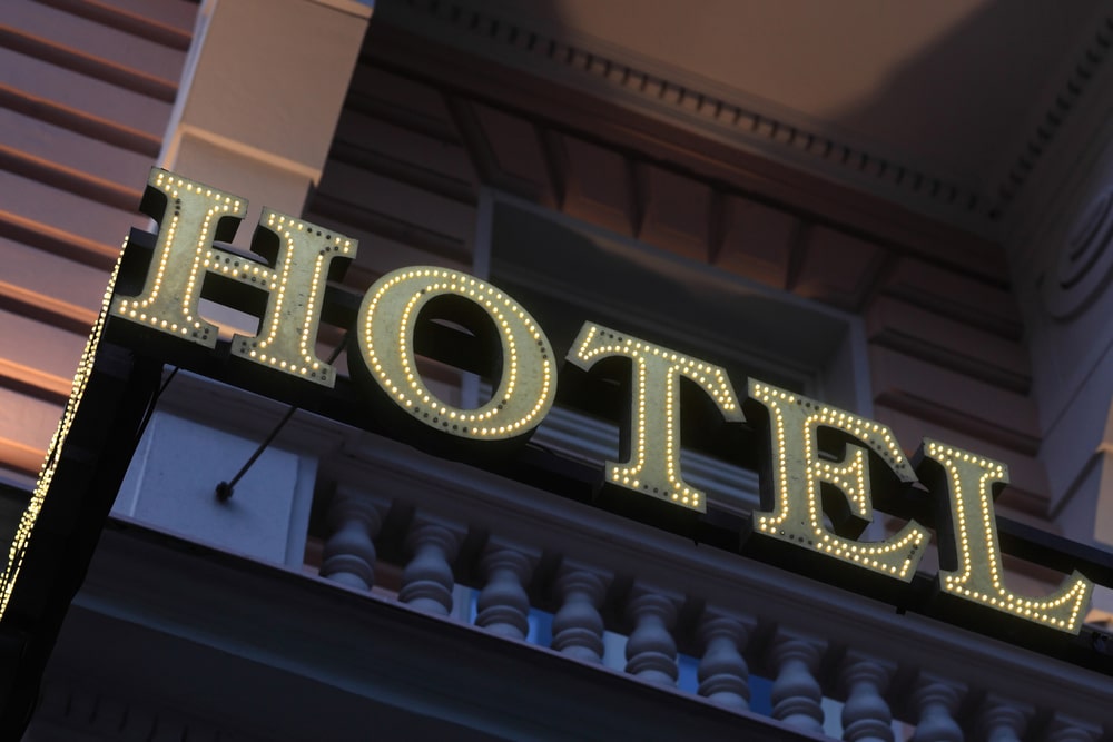 Illuminated hotel sign on the wall of building