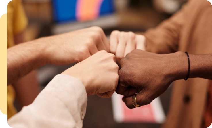 group of hands doing a fist bump gesture