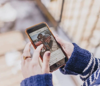 woman browsing on a social media app using her mobile phone