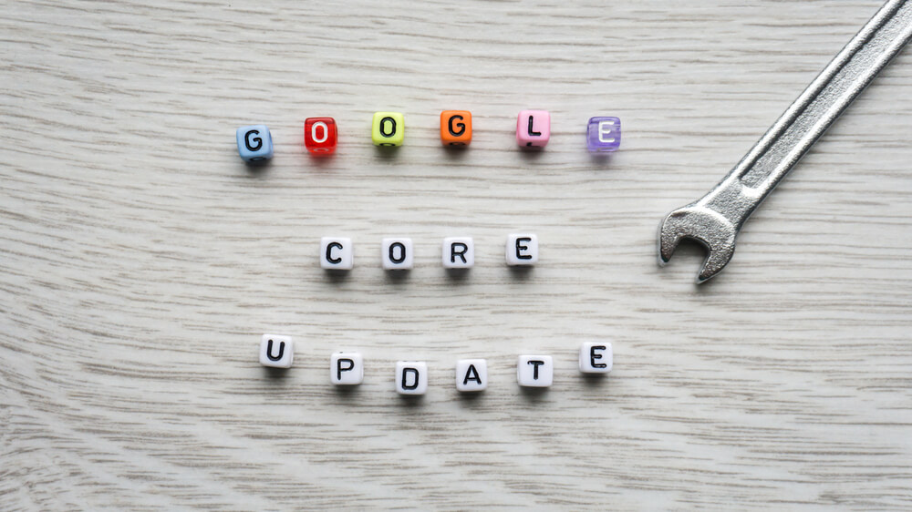 Google Core Update spelled using colourful beads on table with small stainless wrench