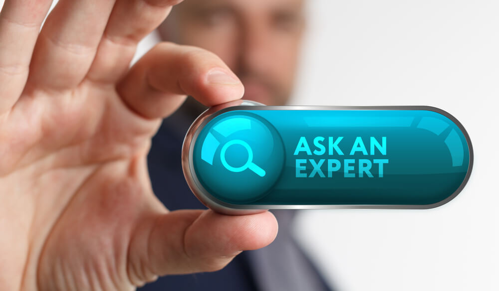 Man holding small screen with search icon and ask an expert text