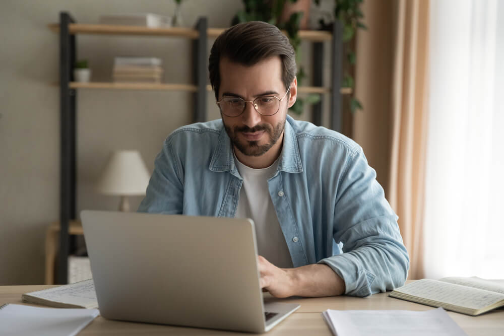 man reading on laptop