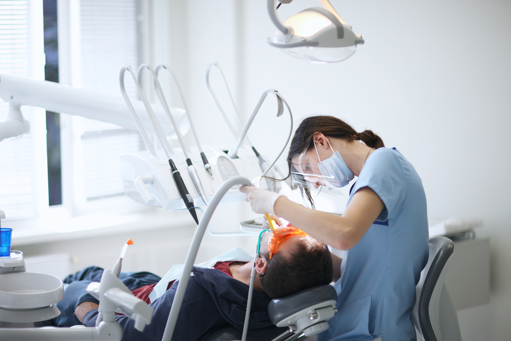 Dentist performing a dental procedure on a patient in a dental chair