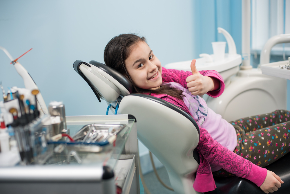 happy kid in her dentist appointment