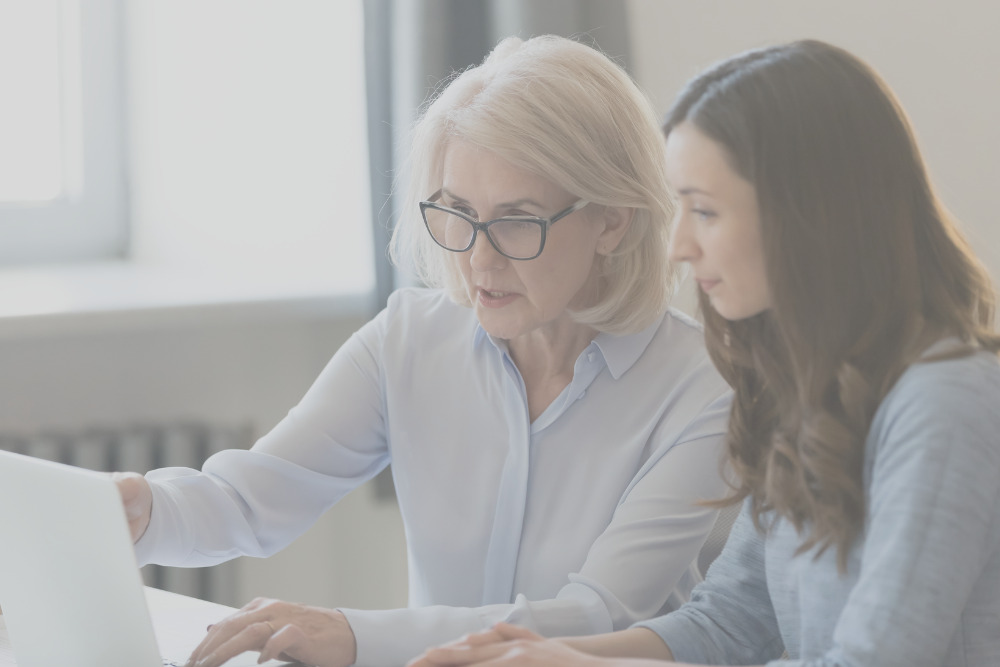 2 women talking about a project