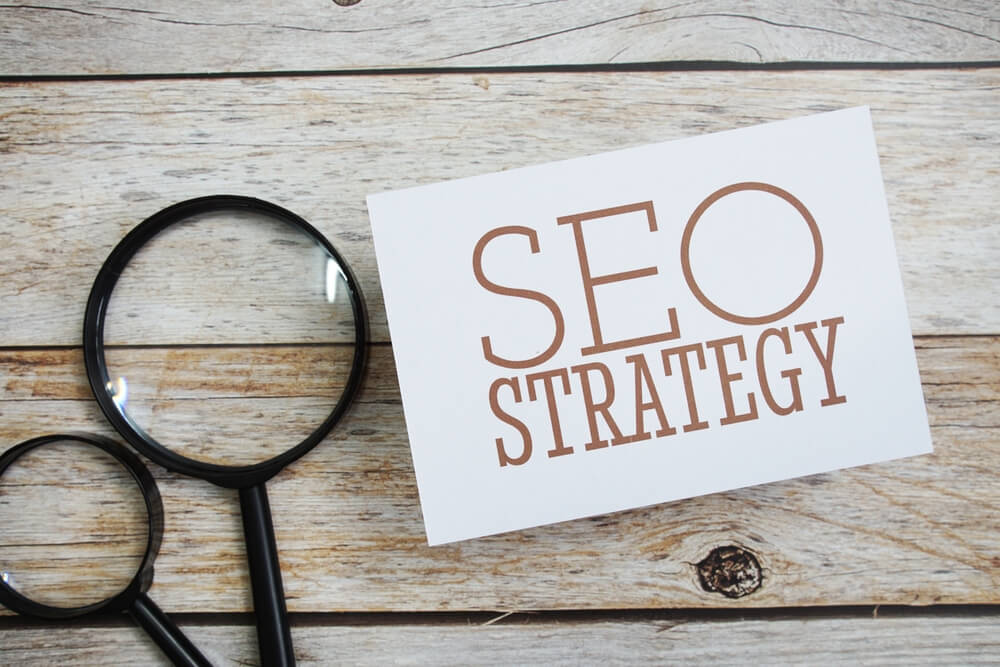 seo strategy on paper with magnifying glass