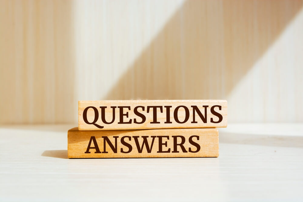 stacked wooden blocks with “Questions” “Answers” written