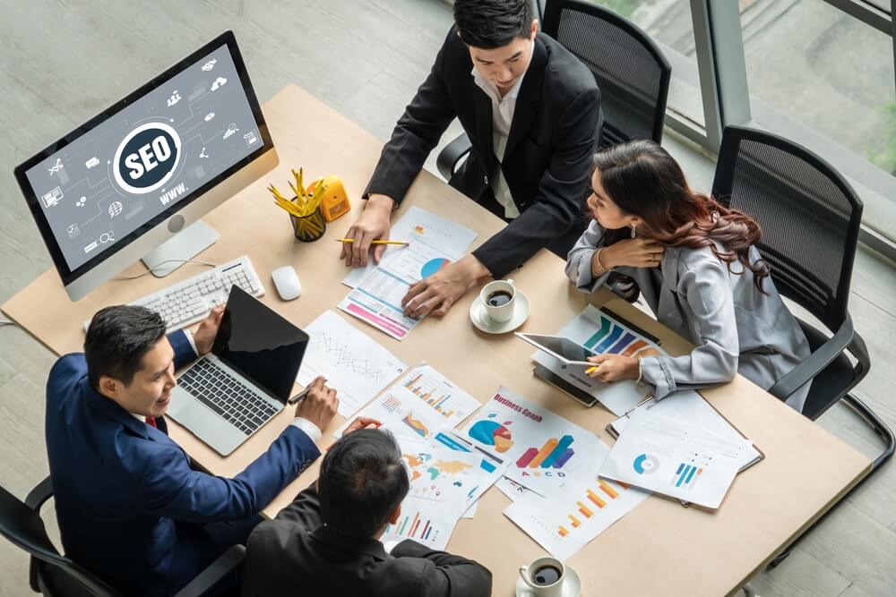 Top view of SEO team discussing strategies in the meeting room