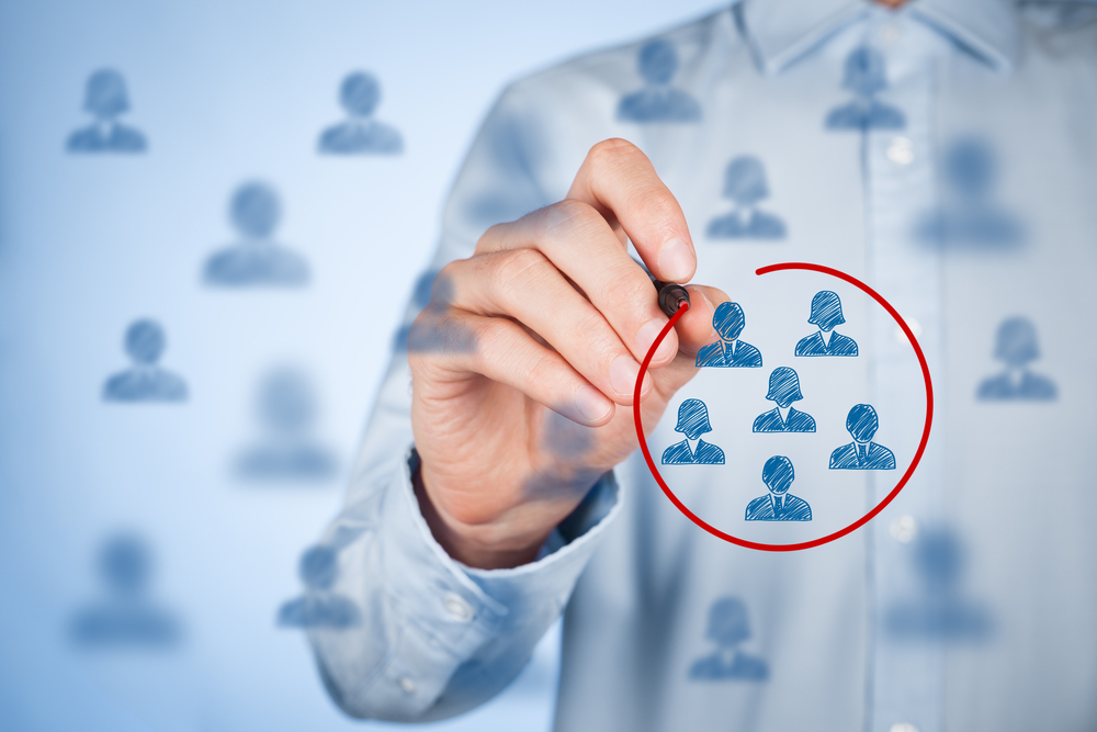 man circling group of people on glass board, target market concept