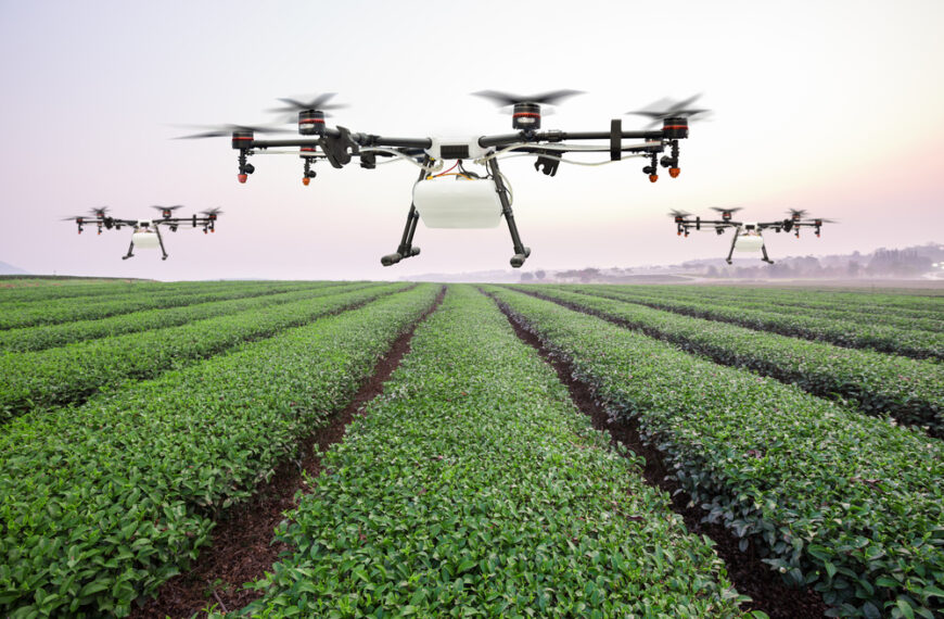 agricultural drones flying over crops